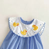 Blue checkered romper with white collar featuring yellow duck appliqués 